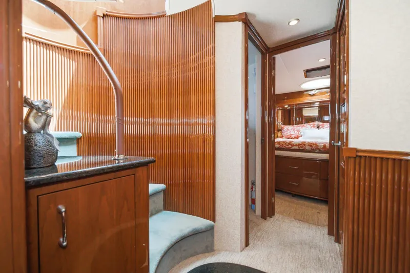 Slide: The Image of Luxurious 2005 Marquis Pilothouse yacht interior with elegant wood paneling and cozy bedroom. - 56