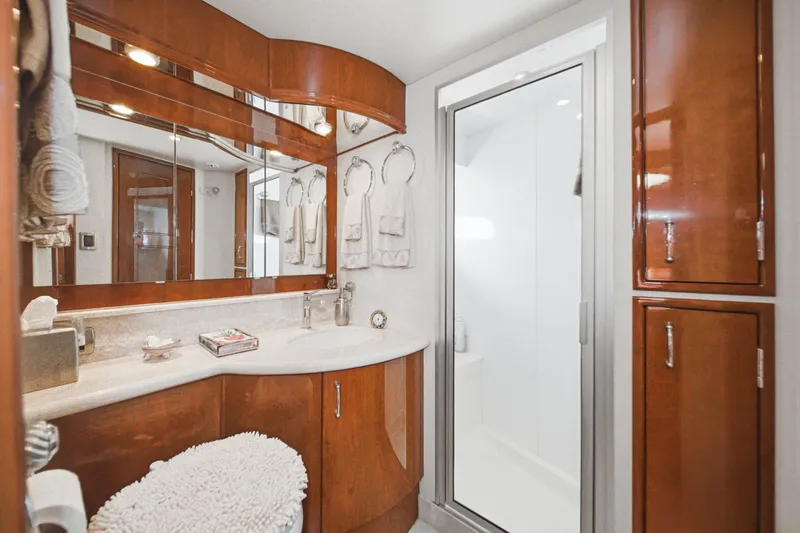 Slide: The Image of Luxurious 2005 Marquis Pilothouse yacht bathroom with wood cabinetry and modern fixtures. - 59