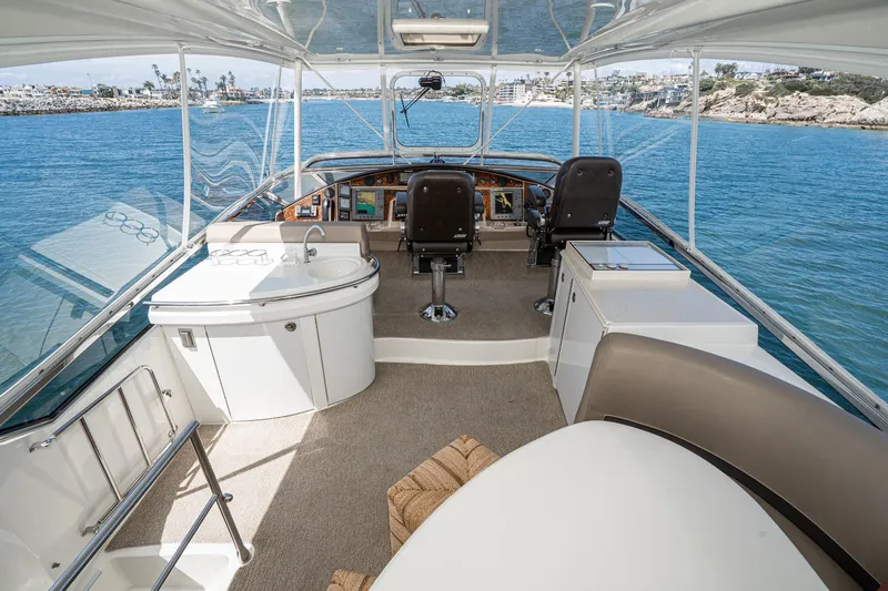 Slide: The Image of Pilothouse interior of 2005 Marquis yacht with helm, seating, and ocean view. - 62