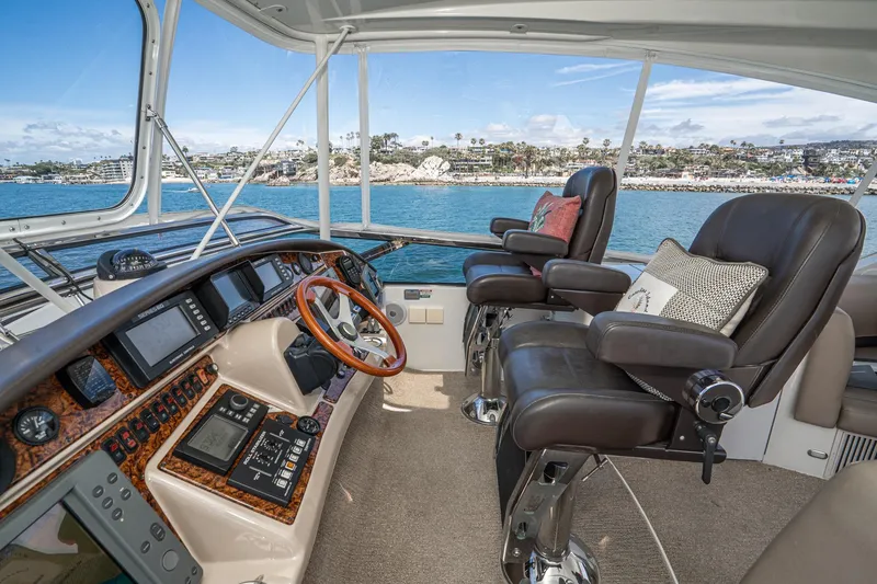 Slide: The Image of Luxurious 2005 Marquis Pilothouse yacht interior with leather seating and advanced navigation controls. - 63