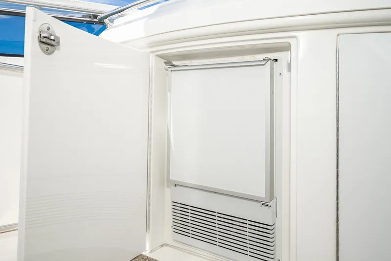 Slide: The Image of Open refrigerator door on 2005 Marquis Pilothouse yacht, showcasing sleek interior design. - 69