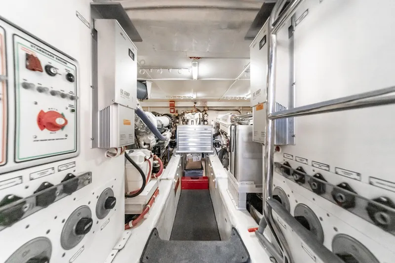 Slide: The Image of Engine room of a 2005 Marquis Pilothouse yacht, showcasing electrical panels and machinery. - 75