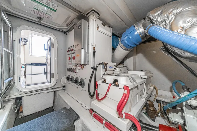 Slide: The Image of Engine room of a 2005 Marquis Pilothouse yacht with electrical panels and equipment. - 81