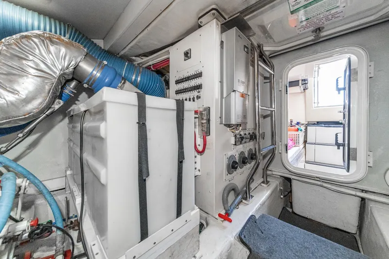 Slide: The Image of Engine room of a 2005 Marquis Pilothouse yacht with electrical panels and ventilation. - 82