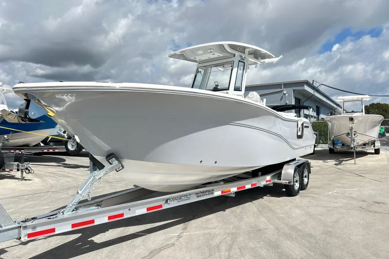The Image of 2026 Sea Fox 268 Commander boat on trailer under cloudy sky. - 0