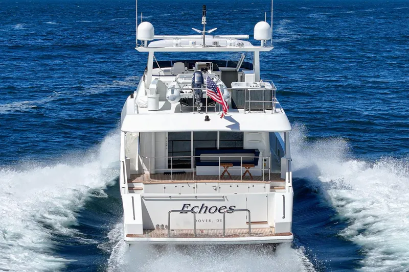 Slide: The Image of Luxury Northcoast Yachts Raised Pilothouse cruising on open sea, rear view. - 17