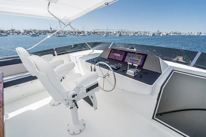 Slide: The Image of Raised pilothouse of Northcoast Yachts, 1999 model, overlooking marina with clear blue skies. - 24