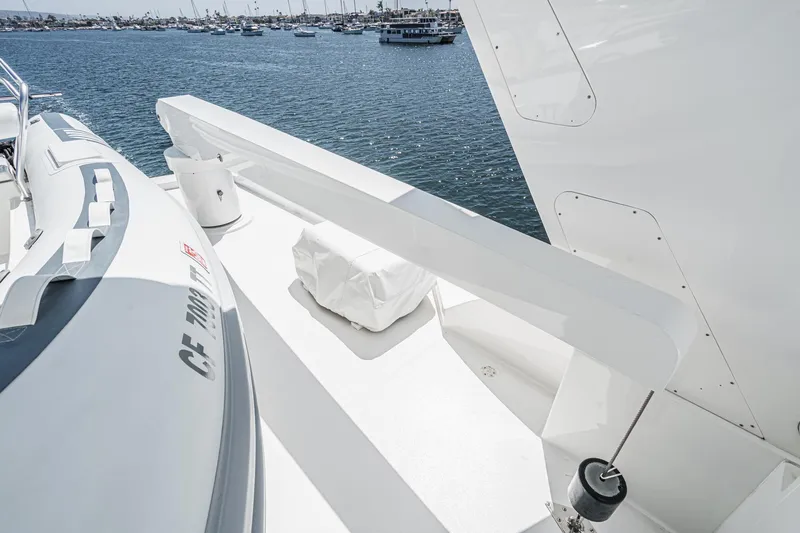 Slide: The Image of Northcoast Yachts Raised Pilothouse 1999, deck view with tender, ocean backdrop. - 34