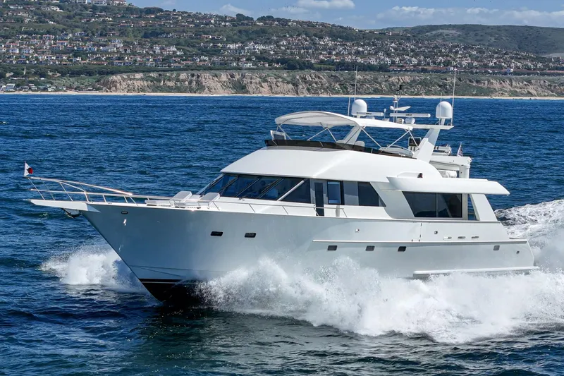 Slide: The Image of Luxurious Northcoast Yachts Raised Pilothouse cruising on the ocean, model year 1999/2024. - 4