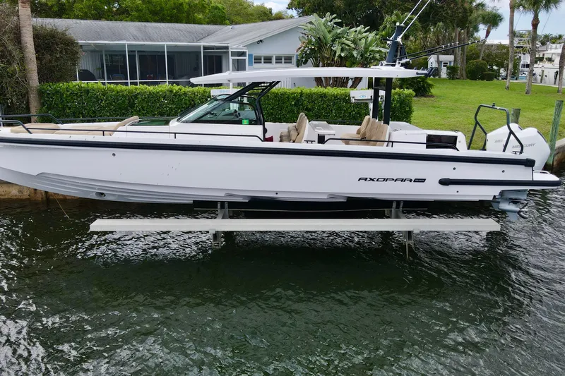 The Image of 2021 Axopar 37 Sun-Top boat docked, showcasing sleek design and modern features. - 0