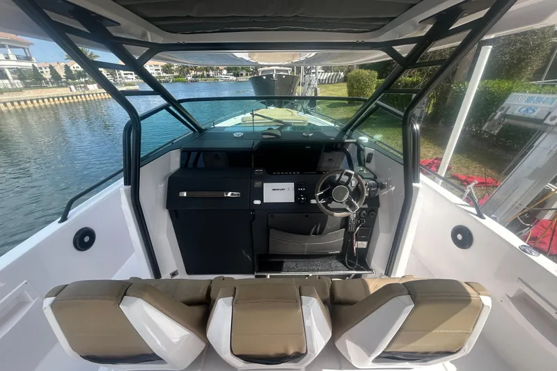 Slide: The Image of 2021 Axopar 37 Sun-Top boat interior with modern helm and seating. - 12