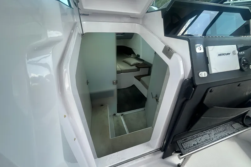 Slide: The Image of 2021 Axopar 37 Sun-Top cabin interior with Mercury controls, showcasing modern design. - 13