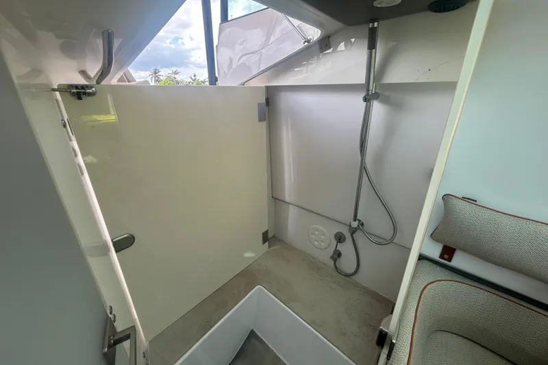 Slide: The Image of Interior of 2021 Axopar 37 Sun-Top boat featuring a compact shower area. - 15