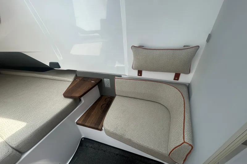 Slide: The Image of 2021 Axopar 37 Sun-Top interior seating with wooden steps and cushioned backrest. - 18