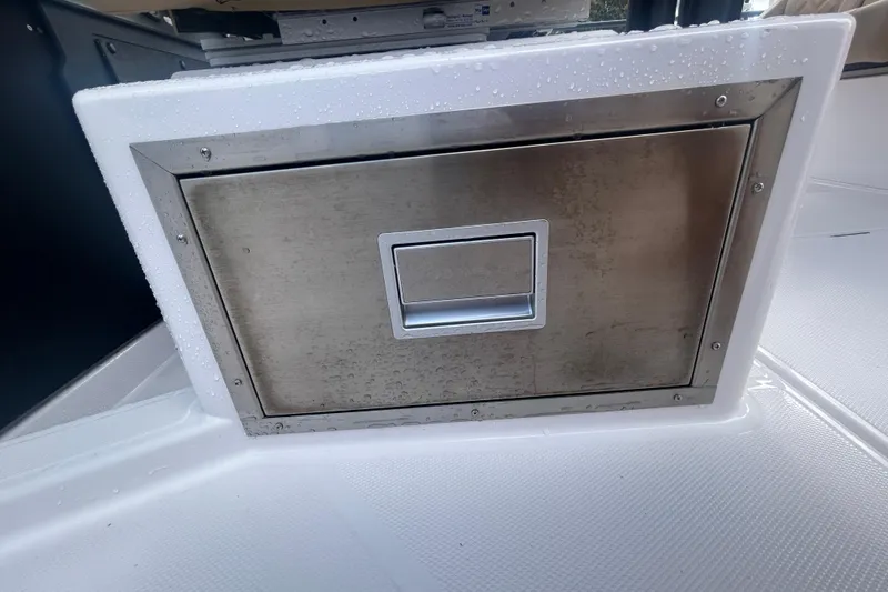 Slide: The Image of Stainless steel storage compartment on 2021 Axopar 37 Sun-Top boat, featuring sleek design. - 19