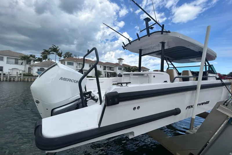 Slide: The Image of 2021 Axopar 37 Sun-Top boat with Mercury engine docked by waterfront homes. - 5