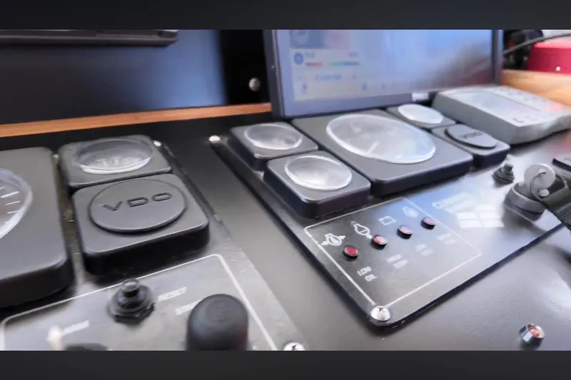Slide: The Image of Control panel of 2002 Transpacific Marine EAGLE 53 yacht, featuring gauges and switches. - 12