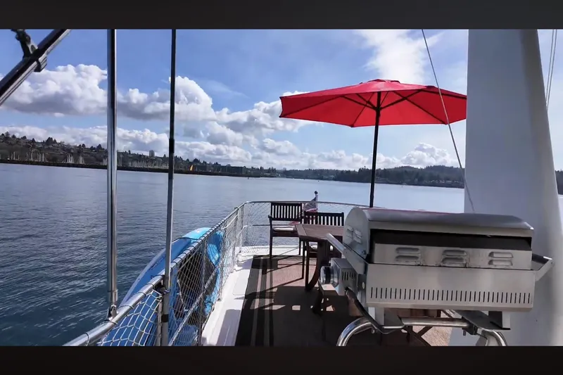 Slide: The Image of Deck of 2002 Transpacific Marine EAGLE 53 yacht with grill and red umbrella. - 13