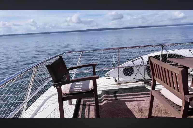 Slide: The Image of Deck view of 2002 Transpacific Marine EAGLE 53 yacht with chairs and ocean backdrop. - 14