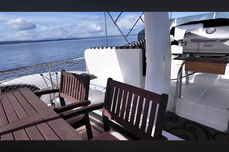 Slide: The Image of Deck of 2002 Transpacific Marine EAGLE 53 yacht with seating and grill, overlooking ocean. - 15
