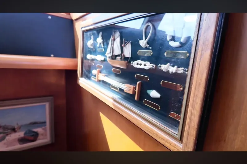 Slide: The Image of Display case with nautical knots and model ship on Transpacific Marine EAGLE 53, 2002. - 16