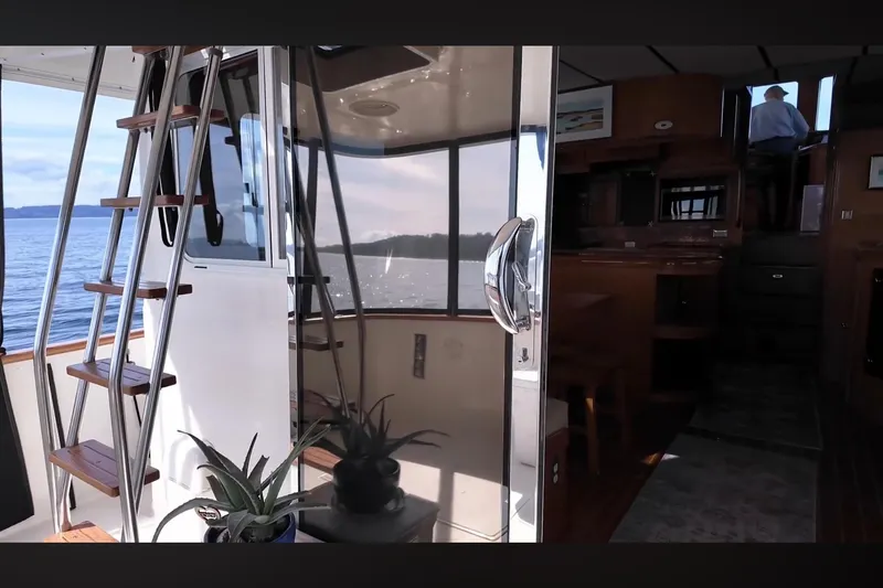 Slide: The Image of Interior view of 2002 Transpacific Marine EAGLE 53 yacht with wooden stairs and potted plants. - 2