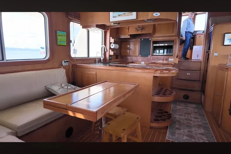 Slide: The Image of Interior of 2002 Transpacific Marine EAGLE 53 yacht with wooden furnishings and seating area. - 4