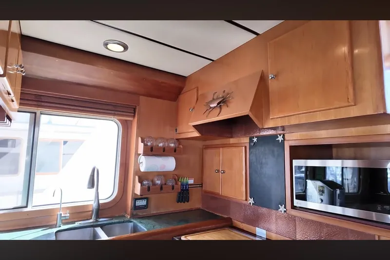 Slide: The Image of Interior of 2002 Transpacific Marine EAGLE 53 yacht kitchen with wooden cabinets and modern appliances. - 7