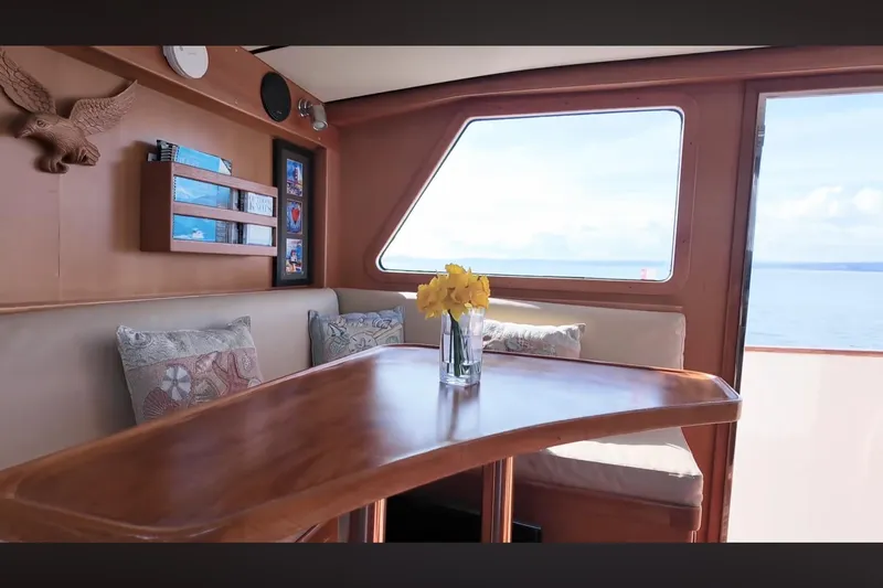 Slide: The Image of Interior of 2002 Transpacific Marine EAGLE 53 yacht with wooden table and sea view. - 8