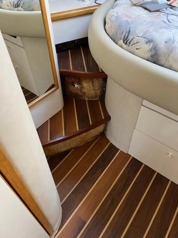 Slide: The Image of Interior of 1995 Sea Ray 450 Sundancer with wooden steps and cozy cabin space. - 16