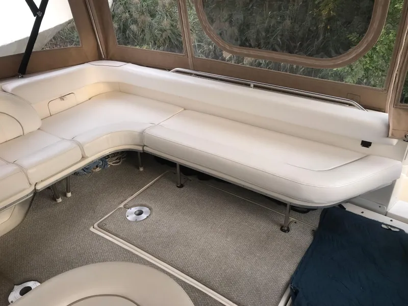 Slide: The Image of 1995 Sea Ray 450 Sundancer interior with beige seating and carpeted floor. - 21