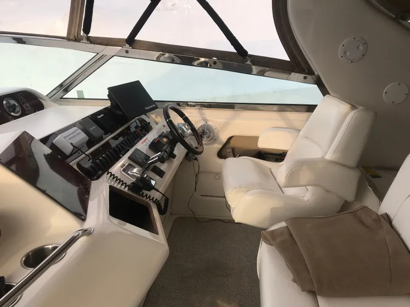 Slide: The Image of Interior helm of 1995 Sea Ray 450 Sundancer yacht with steering wheel and controls. - 22