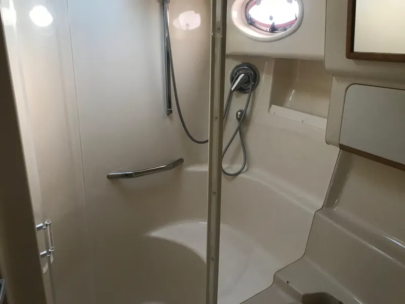 Slide: The Image of 1995 Sea Ray 450 Sundancer bathroom with shower and porthole window. - 26