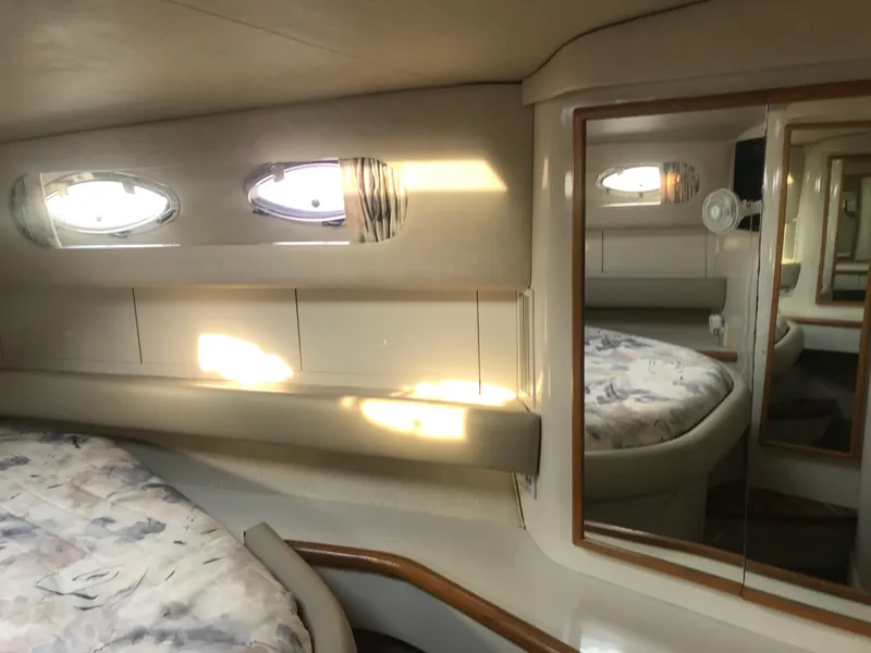 Slide: The Image of Interior cabin of 1995 Sea Ray 450 Sundancer yacht with bed and porthole windows. - 28