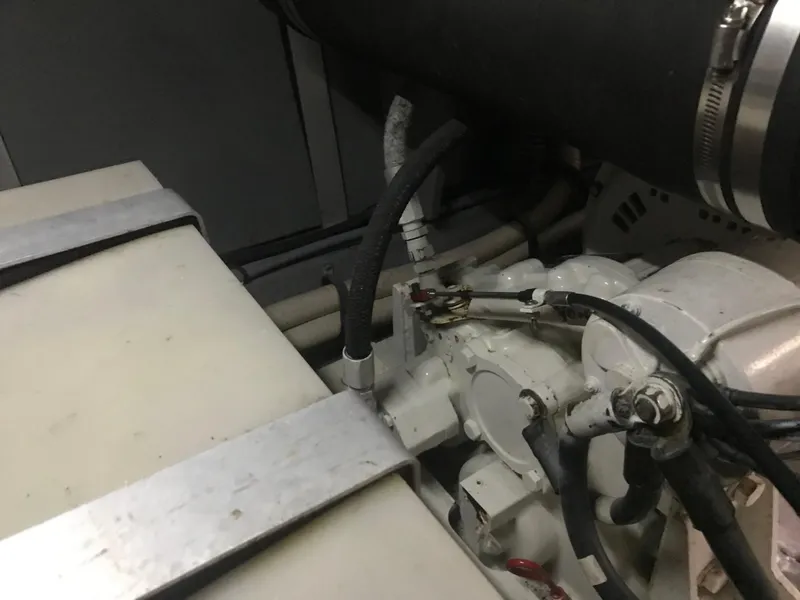 Slide: The Image of Engine compartment of 1995 Sea Ray 450 Sundancer with visible hoses and components. - 35