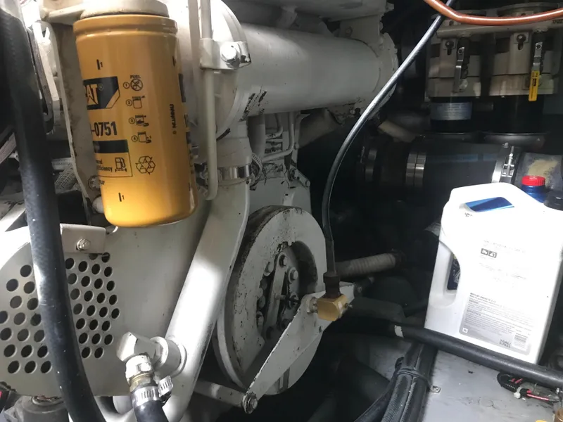 Slide: The Image of Engine compartment of 1995 Sea Ray 450 Sundancer with visible components and oil filter. - 39