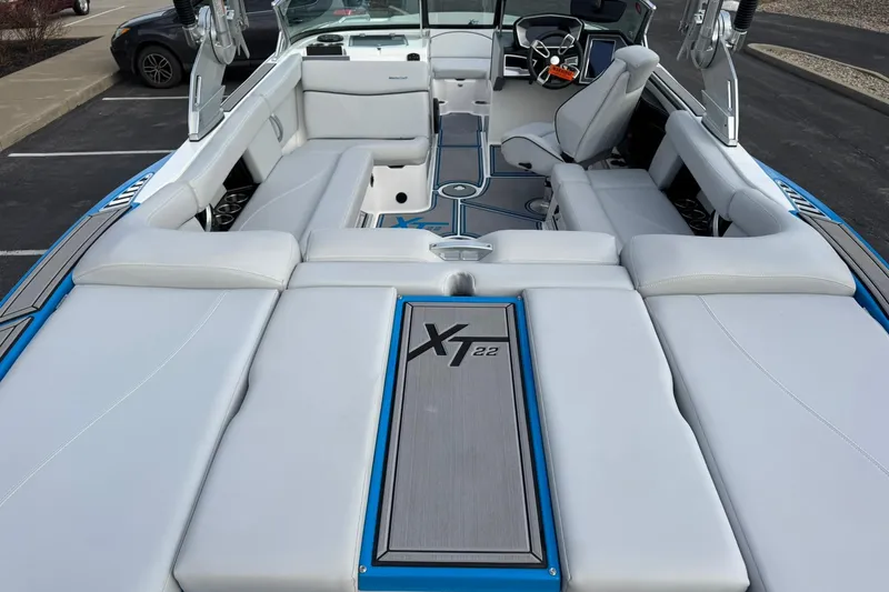 Slide: The Image of 2021 MasterCraft XT22 boat interior with sleek seating and modern dashboard design. - 10