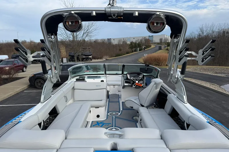 Slide: The Image of 2021 MasterCraft XT22 boat interior with sleek seating and advanced dashboard. - 11