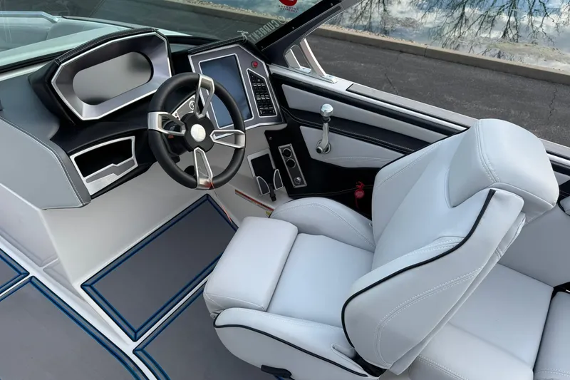 Slide: The Image of 2021 MasterCraft XT22 boat interior with modern steering and dashboard design. - 13