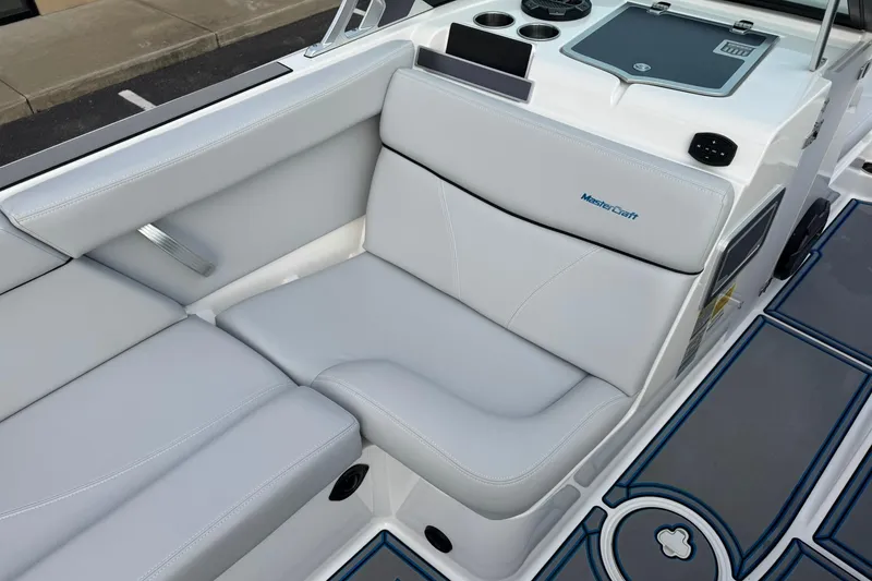 Slide: The Image of 2021 MasterCraft XT22 boat interior with gray seating and cup holders. - 14