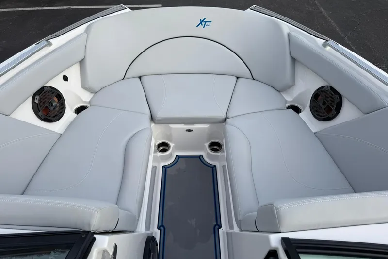 Slide: The Image of 2021 MasterCraft XT22 boat interior with gray seating and built-in speakers. - 15
