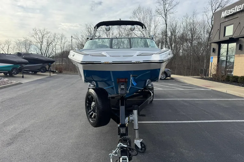 Slide: The Image of 2021 MasterCraft XT22 boat on trailer in parking lot, front view. - 7