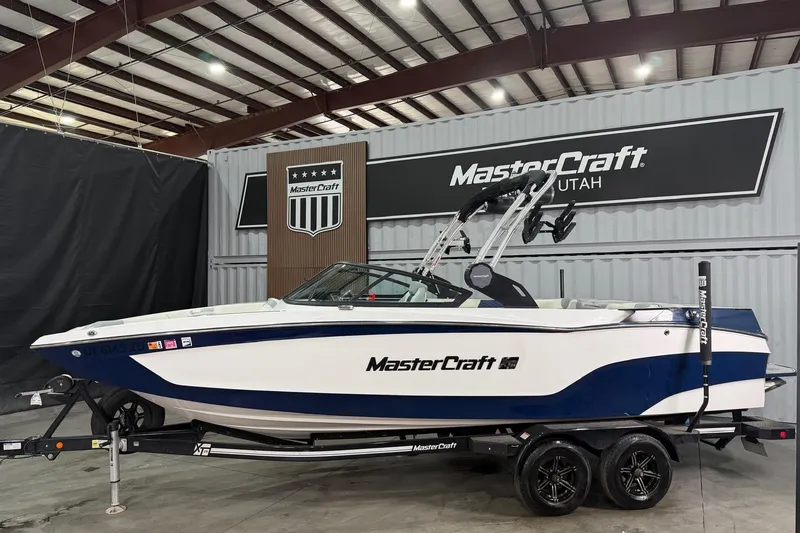 The Image of 2022 MasterCraft XT24 boat in a showroom. - 1