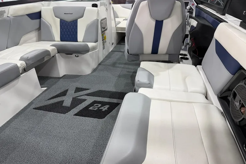 Slide: The Image of 2022 MasterCraft XT24 boat interior with stylish seating and carpeted flooring. - 10