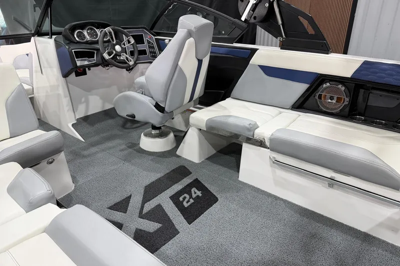 Slide: The Image of 2022 MasterCraft XT24 boat interior with modern seating and dashboard design. - 11