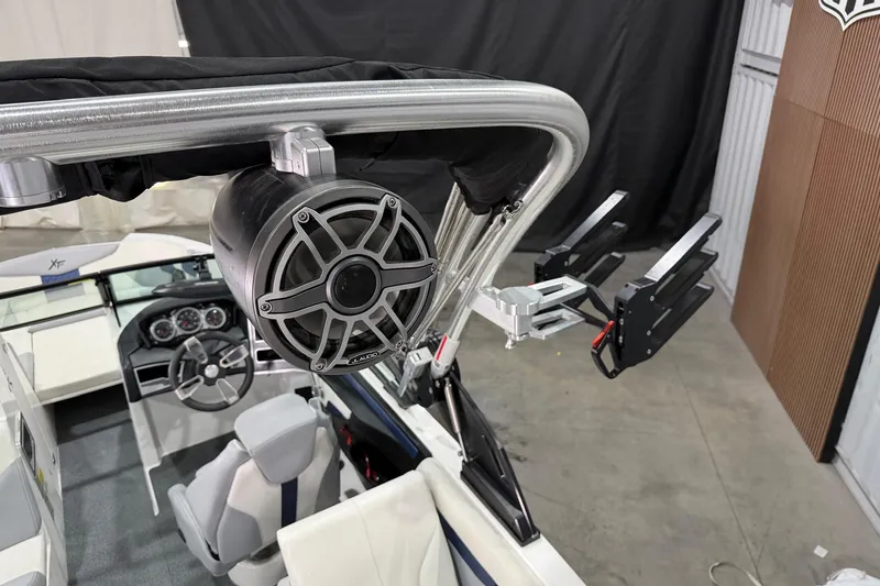 Slide: The Image of 2022 MasterCraft XT24 boat interior with speaker and wakeboard rack. - 13