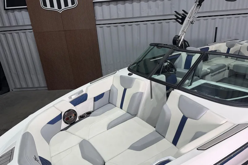 Slide: The Image of 2022 MasterCraft XT24 boat interior with white and blue seating, sleek design. - 3
