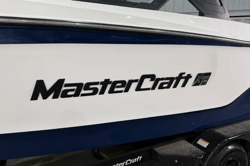 Slide: The Image of 2022 MasterCraft XT24 boat side view with logo and model name. - 4
