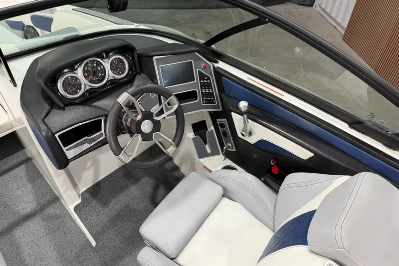 Slide: The Image of 2022 MasterCraft XT24 boat interior with modern dashboard and steering wheel. - 7