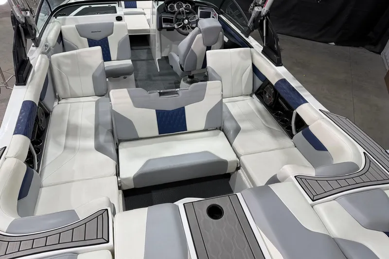 Slide: The Image of 2022 MasterCraft XT24 boat interior with white and blue seating, modern design. - 8